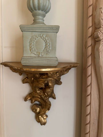 Petite wall shelf with intense rococo scroll
