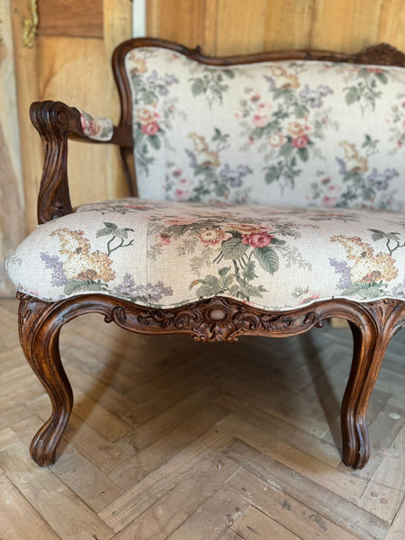 Louis XV settee with naturalistic motifs ~