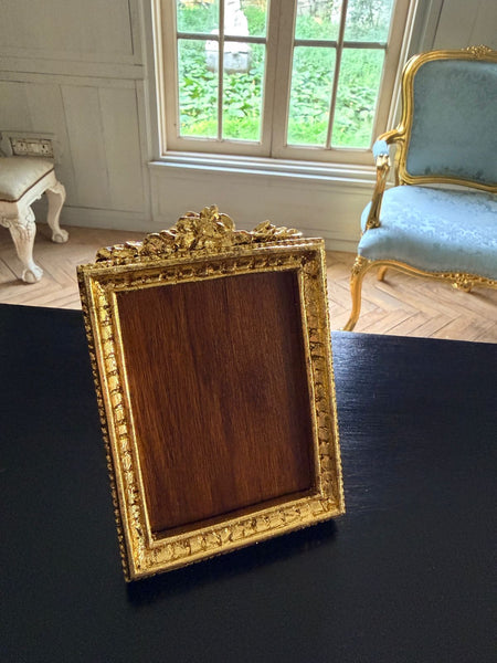 Louis XVI petite frame with floral cartouche~