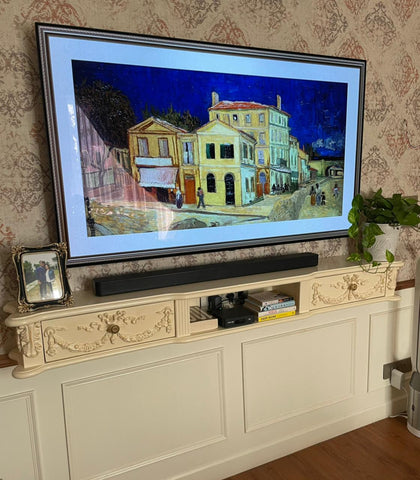 Floating media shelf with wreaths and ribbons inspired by The Unfurling