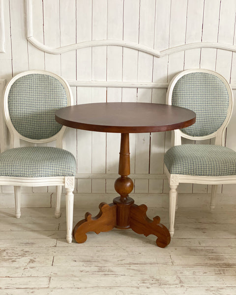 A set of two Louis XVI chairs with a petite table