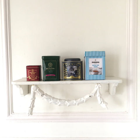 Shelf with delicate floral wreaths