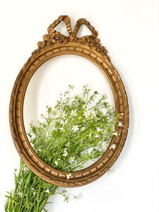 Frame in oval shape from The Unfurling with delicate ribbon