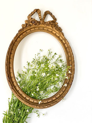 Frame in oval shape from The Unfurling with delicate ribbon