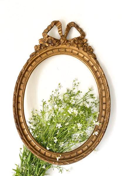 Frame in oval shape from The Unfurling with delicate ribbon