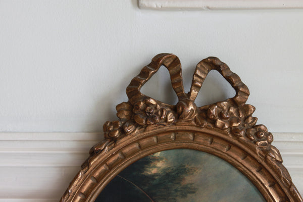 Frame in oval shape from The Unfurling with delicate ribbon