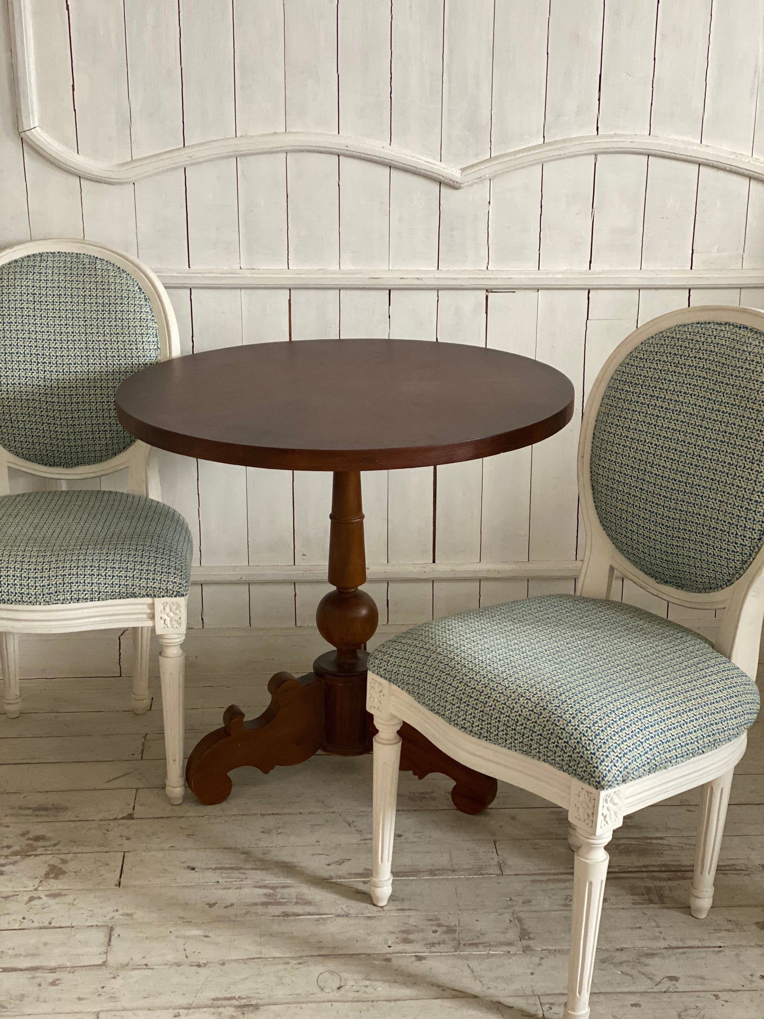 A set of two Louis XVI chairs with a petite table