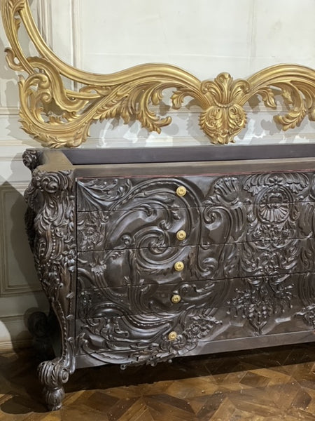 Surreal bombé commode with dramatic rococo scrolls