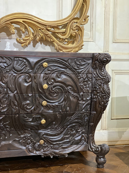 Surreal bombé commode with dramatic rococo scrolls