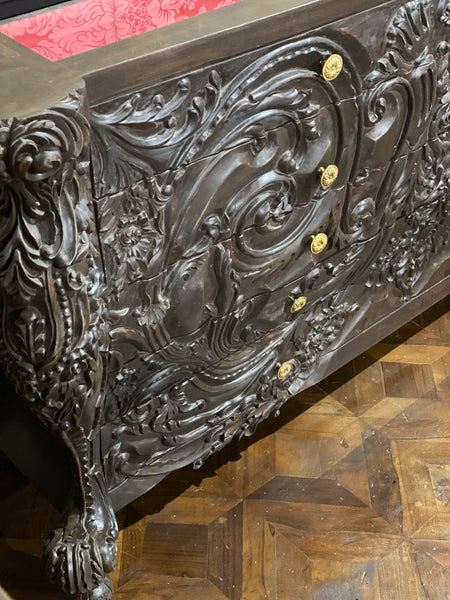 Surreal bombé commode with dramatic rococo scrolls